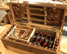 a wooden box filled with lots of different types of woodworking tools in it's storage compartment