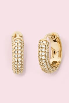 Each piece in Kate Spade's brilliant statements collection is true to its name   sparkly, eye-catching and always timeless. These domed mini huggies, which they've crafted of gold-tone metal are adorned with glimmering pave crystals. Mix them with other studs or allow them to turn heads all on their own. Designed with a plated metal and cubic zirconia. Complete with brass posts with spade backs. Huggie Earrings Gold, Stacked Jewelry, Huggie Earrings, Girly Jewelry