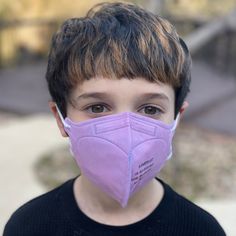 The only 100% American-Made KN95 for kids. Our USA-Made KN95 kids masks are not just constructed in the US with 100% American-made materials, they're also produced in a FDA-registered facility that produces NIOSH Approved N95 masks alongside them. KN95 masks are an incredibly popular respirator design. The cone shape provides a tighter seal than surgical masks, while many find the ear loops more comfortable than the head straps found on traditional cup-style N95 masks. It's a good design, but af Kn95 Mask, Kids Packaging, Kids Masks, Purple Cases, Pink Mask, Wide Face, N95 Mask, White Mask, Purple Bag