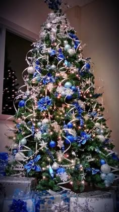 a christmas tree decorated with blue and silver ornaments