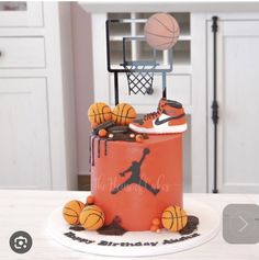 a birthday cake with basketballs and shoes on it, sitting on top of a table