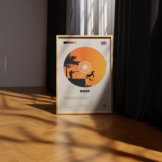 an image of a movie poster on the floor in front of a window with curtains