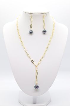 This necklace and earring set is made of gold-plated stainless steel, which makes it both strong and beautiful. The necklace features a dark pearl pendant that adds a touch of elegance. The earrings are designed to match the necklace, so you can create a coordinated look. Elegant Gold Tahitian Pearl Jewelry, Tahitian Pearl Jewelry With Matching Earrings For Gift, Gold Tahitian Pearl Jewelry With Pearl Charm, Tahitian Pearl Jewelry Set With Matching Earrings For Gift, Gold Tahitian Pearl Earrings Gift, Dark Pearl, Necklace And Earring Set, Tennis Bracelet, Christmas Sale