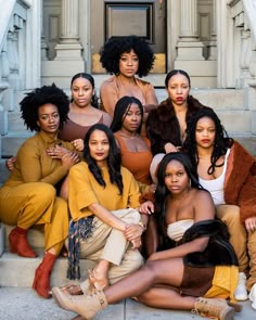 a group of women sitting next to each other on steps