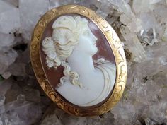 "Here is another wonderful piece from a friend's grandmother's collection of jewelry, and this cameo likely came from that lady's grandmother.  It is a beauty, with a detailed high relief carved image of Psyche, with a draped gown and butterfly wings in her hair. The brooch measures slightly under 2\" high and is 1 1/2\" wide and is signed '10k' on the lever style clasp.  The piece weighs 9.7 grams and is in very good antique condition with no flaws that I have seen.  There is a bit of dust in t White Oval Cameo Brooches, Collectible Oval Cameo Brooch, Collectible Oval Cameo Brooches, Oval Cameo Brooches As Gift, Carved Oval Brooch As Gift, Carved Oval Brooch For Gift, Heirloom Cameo Brooches For Collectors, Oval Intaglio Brooches For Anniversary, Heirloom Cameo Brooch Gift