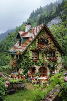 a house with lots of flowers growing on the side of it's roof and windows