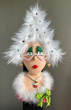 a mannequin with white feathers and green eyes