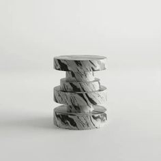 three stacked marble pedestals on a white background