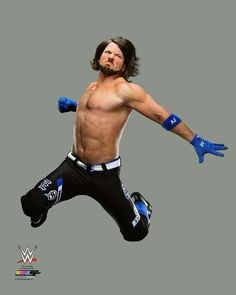 a man with long hair and no shirt jumping in the air wearing blue boxing gloves