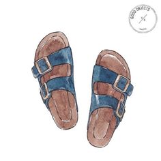 a pair of blue and brown sandals with buckles on the bottom, sitting in front of a white background