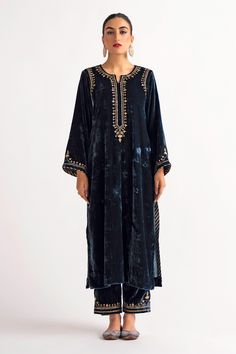 Deep blue velvet kurta, featuring longline hem in straight silhouette, highlighted with placement contrast hand embroidery. Paired with a straight pant.
Components: 2
Pattern: Placement Hand Embroidery
Type Of Work: Sequin, Zari, Flower
Neckline: Notched Round Neck
Sleeve Type: Full Sleeves
Fabric: Velvet
Color: Blue
Other Details: 
Floral hand embroidery on the back of the kurta
Placement floral hand embroidered pant
Occasion: Puja,Mehendi and Haldi - Aza Fashions Velvet Suit Design, Velvet Kurta, Ramadan 2024, Velvet Suit, Recipes Indian, Embroidered Pants, Suit Design, Embroidered Neckline, Kurta With Pants