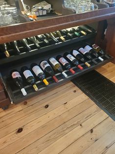 the wine rack is full of bottles and glasses