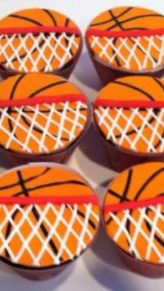 six basketball cupcakes with white and orange net on them are ready to be eaten