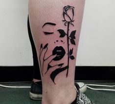 a woman's leg with a rose tattoo on it