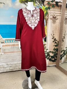 Elevate your winter wardrobe with our traditional Kashmiri Pheran crafted from a mix of wool fabrics, complete with two side pockets and delicate Ari work embroidery. Inspired by centuries of Kashmiri tradition, these Pherans offer both warmth and elegance, perfect for cold weather outings. The intricate till work embroidery adds a touch of sophistication to this timeless garment, making it a must-have for any discerning fashion enthusiast. Stay cozy and stylish with our Kashmiri Pheran, blendin Elegant Floral Embroidered Kurta For Winter, Semi-stitched Unstitched Suit With Embroidered Border, Designer Long Sleeve Kaftan With Zari Work, Ceremonial Embroidered Jamawar Churidar, Ceremonial Embroidered Churidar In Jamawar, Designer Unstitched Suit With Embroidered Border And Long Sleeves, Embroidered Long Sleeve Churidar For Wedding, Long Embroidered Salwar Kameez For Diwali, Festive Long Sleeve Salwar Kameez With Embroidered Border