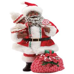 a santa clause figurine standing next to a bag of candy canes on a white background