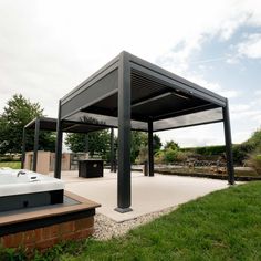 a hot tub sitting under a black metal structure