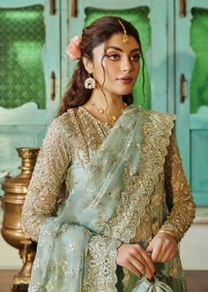 Kameez Trouser Style Sea Green Pakistani Wedding Dress is a stunning attire adorned with lavish designs and hand-crafted details of shimmering ornaments and goldwork, making this beautiful Pakistani Dress an epitome of beauty and your foremost priority to wear on the big day. Embellished Kameez: The kameez in an alluring sea green shade is beautifully adorned with gold work and embroideries. The fine details of tilla. resham, sequins, beads, and stones make this Pakistani Wedding Dress an epitome of grace. The shimmering ornaments give a glamorous touch to the kameez in organza fabric. Kameez Trouser: The embellished kameez is paired with a perfectly stitched trousers, creating a traditional Pakistani Wedding Dress. The trousers are in raw silk fabric and they look perfect with the premium Kanwal Malik, Green Dupatta, Pakistani Designer Clothes, Luxury Pret, Raw Silk Fabric, Wedding Types, Pakistani Wedding Dress, Lace Accessories, Wedding Sale