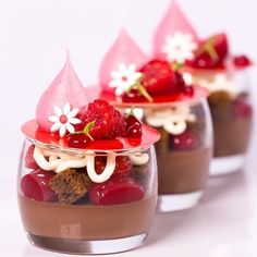 three desserts with strawberries, chocolate pudding and whipped cream in small glass dishes