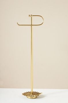 a gold metal towel rack on a white table