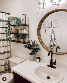 a bathroom with a toilet, sink and mirror