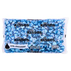 blue chocolate kisses are in a bag on a white background with the words kisses