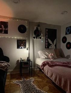 a bed room with a neatly made bed and pictures on the wall