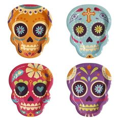 three different colored skulls are shown in this image, one is painted with flowers and the other has a cross on it