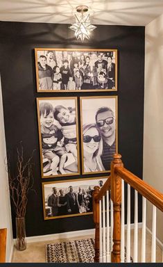 a staircase with pictures on the wall above it