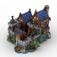 a lego model of a castle with lots of windows and roofing on top of it