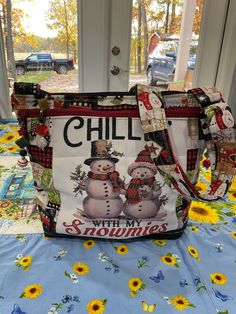 a handbag with snowmen on it sitting on a table