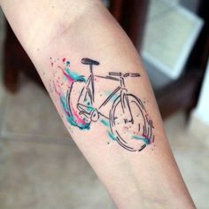 a colorful bicycle tattoo on the arm