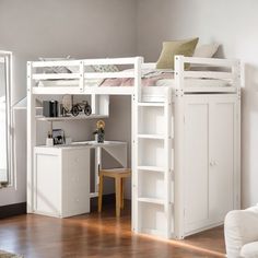 a white bunk bed sitting next to a desk in a room with wooden floors and walls