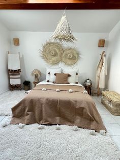 a large bed sitting under a wooden ceiling next to a white rug on top of a hard wood floor