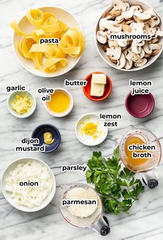 the ingredients to make mushroom soup are shown in bowls on a marble countertop, including mushrooms, lemon zest, parmesan, parsley, parmesan cheese and more