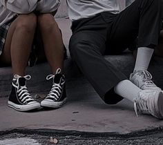 two people sitting on the ground with their legs crossed