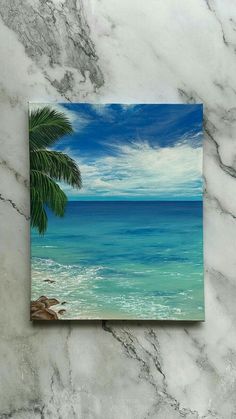 a painting of the ocean and palm trees on a marble counter top with white veining