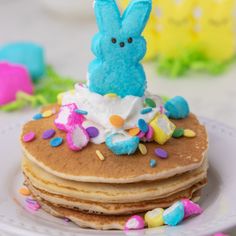 a stack of pancakes with frosting and sprinkles on them, decorated like a bunny