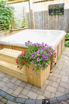 a hot tub with flowers growing in it