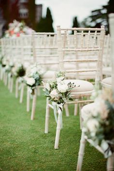 rows of chairs lined up with flowers on them