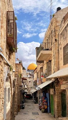 an alleyway in the old city with stone buildings