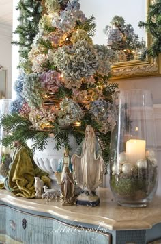 a decorated christmas tree in a living room with candles and ornaments on the mantles