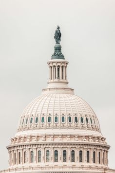 the dome of the u s capitol building with a statue on it's top