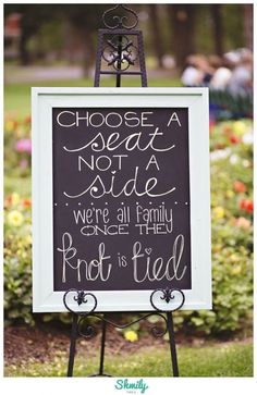 a chalkboard sign that says, choose a seat not a side we're all family