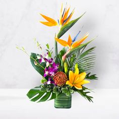 Tropical Saunter - DGM Flowers  | Fort Lauderdale Florist Jungle Baby Flowers Bouquet, Safari Table Centerpieces Flowers, Island Flowers For Wedding, Hawaiian Flower Arrangements, Pin Cushion Protea, Orange Lilies, Tropical Elements, Tropical Centerpieces, Tropical Floral Arrangements