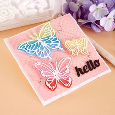 a close up of a card with butterflies on it and the word hello written in black