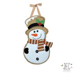 a snowman ornament hanging on a wall