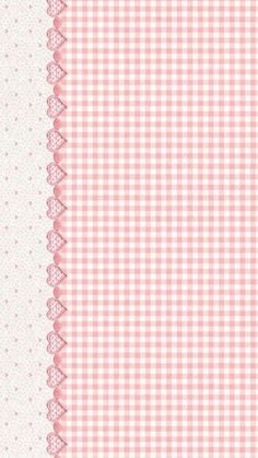 a pink and white checkered table cloth with lace on the edge, in front of a