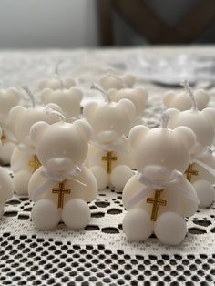 small teddy bears with crosses on them sitting on a table