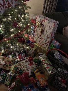 a christmas tree with many presents under it